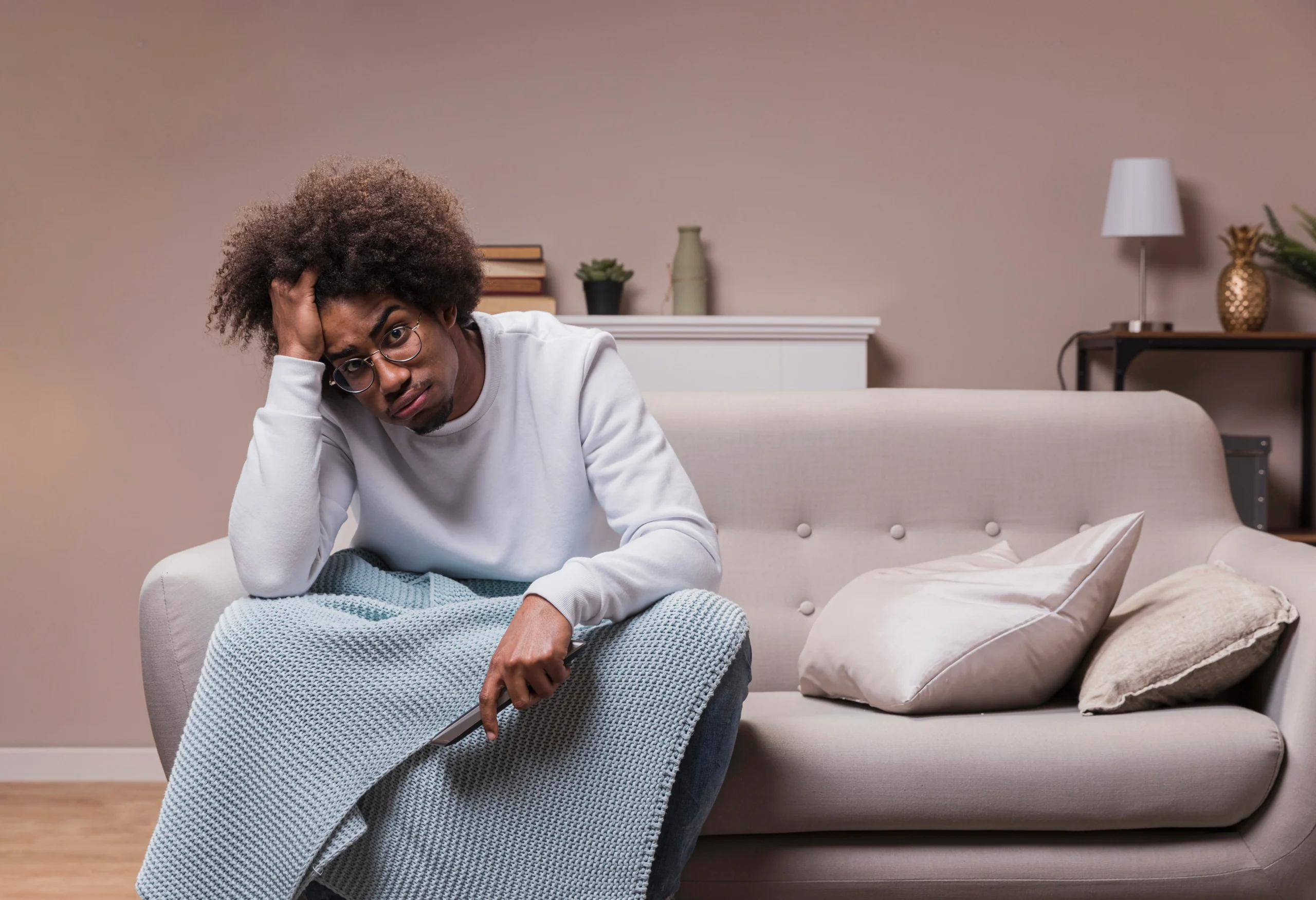 Person feeling tired and overwhelmed while sitting quietly at home